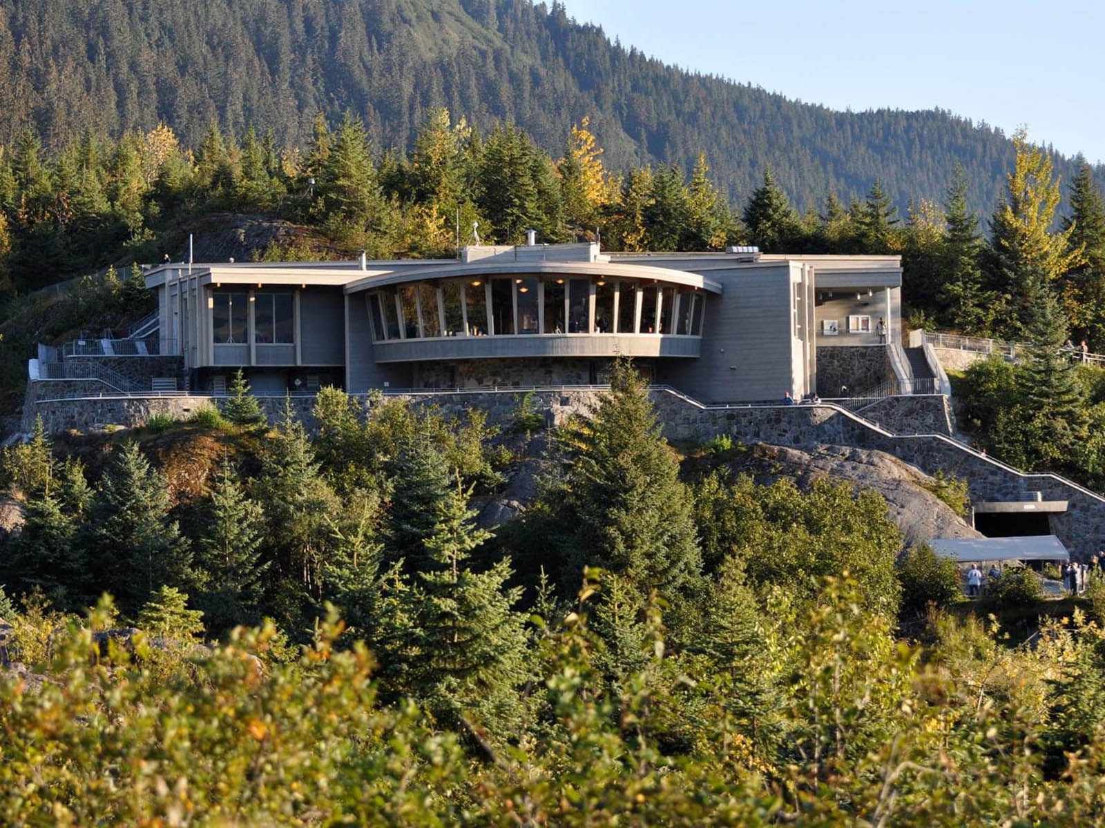 View of the Mendenhall Glacier Visitor Center with the forest in the background