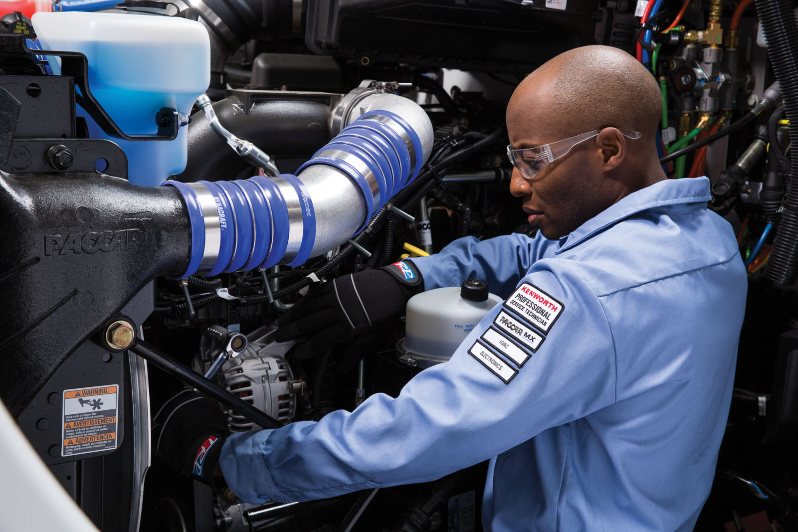 Close up of Kenworth mechanic working on engine